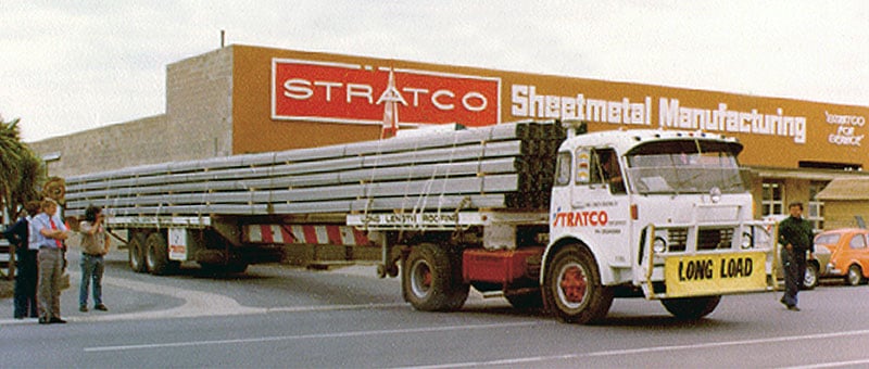 Stratco Sheet Metal Manufacturing Building with delivery truck exiting driveway